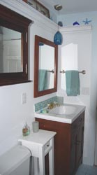 medicine cabinet and small table for additional surface and storage.